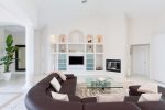 The living room features a built in entertainment center and flat panel TV